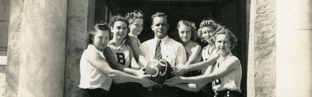 7 people holding the same basketball at the same time