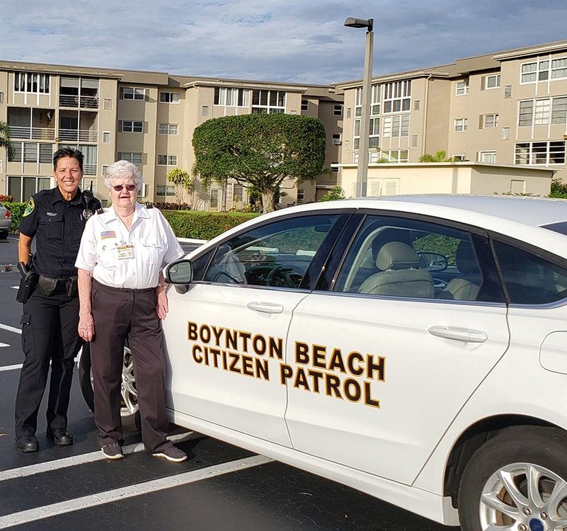 Citizen Observer Patrol Officers Beside a Car