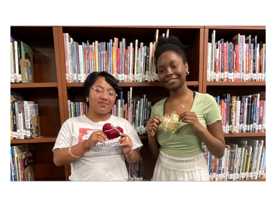 Two teens holding handmade quilted hearts